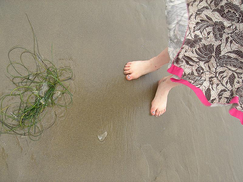 Seaweed, feet and sand.