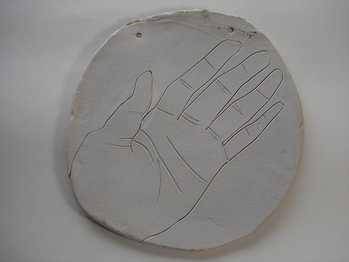 engraved hand in clay