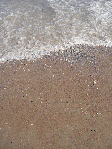 Little wave crashing on Coney Island sand