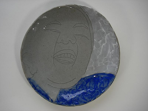 Woman laughing drawing etched on clay