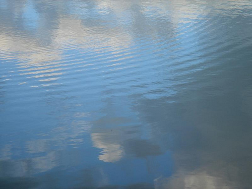 Reflections of clouds in rippled water